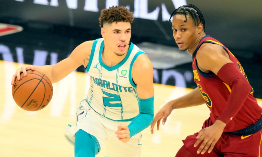 Dec 23, 2020; Cleveland, Ohio, USA; Charlotte Hornets guard LaMelo Ball (2) moves the ball against Cleveland Cavaliers guard Isaac Okoro (35) in the first quarter at Rocket Mortgage FieldHouse. Mandatory Credit: David Richard-USA TODAY Sports