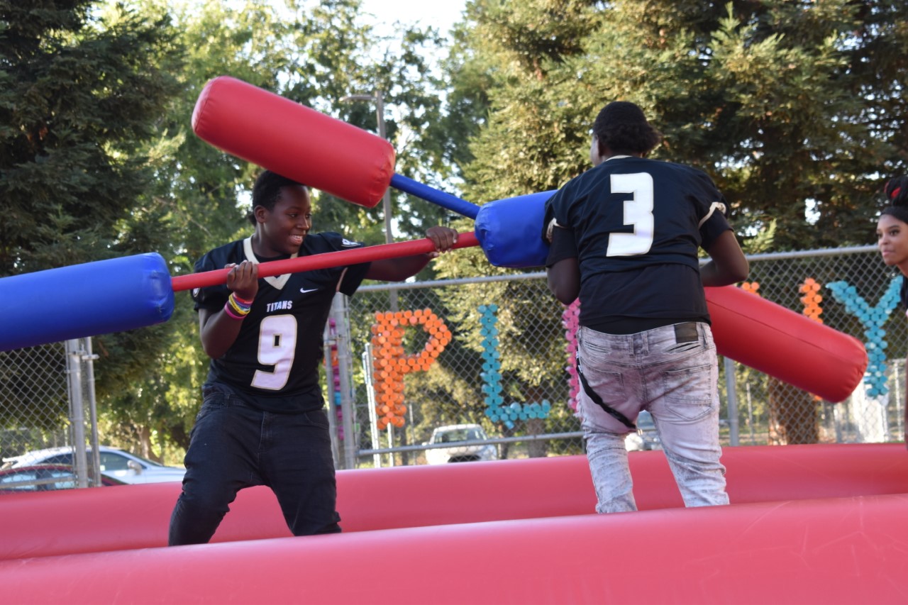 JV Football Players Quadarrious White (#9) and Treavon Spivey enjoy the bounce joust house as back to school night. 