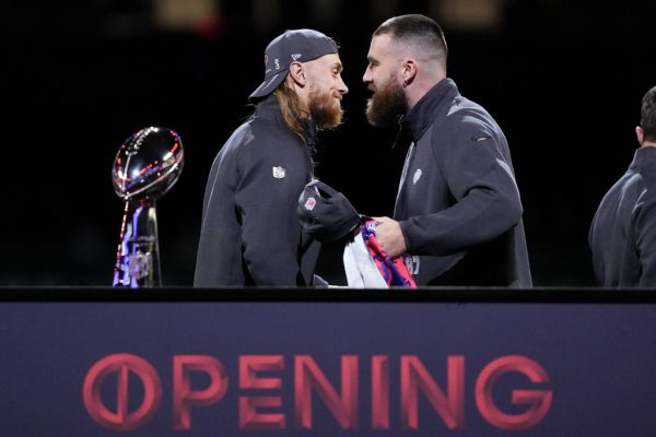 San Francisco 49ers tight end George Kittle and Kansas City Chiefs tight end Travis Kelce shake hands during NFL football Super Bowl 58 opening night Monday, Feb. 5, 2024, in Las Vegas. The San Francisco 49ers face the Kansas City Chiefs in Super Bowl 58 on Sunday. (AP Photo/Matt York)
